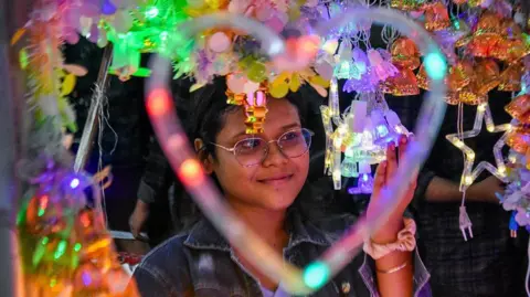 A lady shops for decorative lights ahead of the Diwali festival celebration in Kolkata, India, on 15 October 2025. 