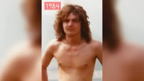 Neil Meynell Neil Meynell at Monsters of Rock music festival in 1984 - he has long, light brown, curly hair to his shoulders, is topless and wearing a thin necklace