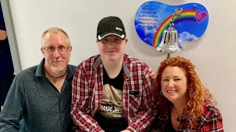 Family photo Jonathan, Daniel and Catherine smiling side by side in hospital
