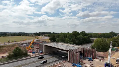 drone footage of construction work on a bridge over a dual carriageway