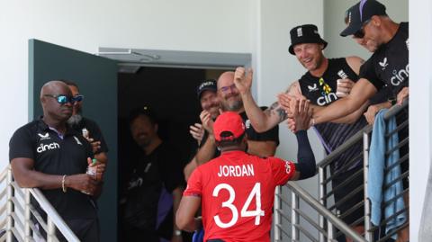 Chris Jordan is acknowledged by the England coaching staff as he returns to the changing room