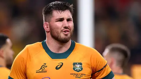 Liam Wright in a gold and green Australia jersey