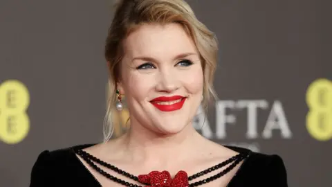 EPA Emerald Fennell smiling on a Bafta red carpet