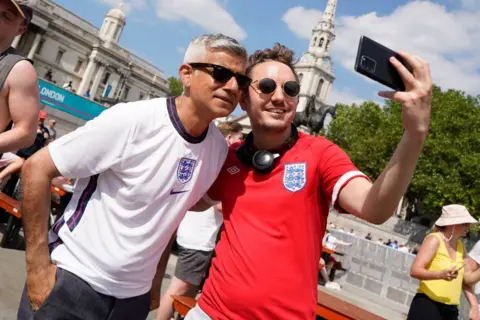 Getty Sadiq Khan poses for a selfie-photograph as he joins England supporters celebrating England's victory at the fan zone in central London after watching the football UEFA EURO 2020 match between England and Croatia