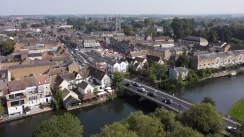 Ant Saddington/BBC An aerial view of St Neots, showing cars crossing a bridge over a river