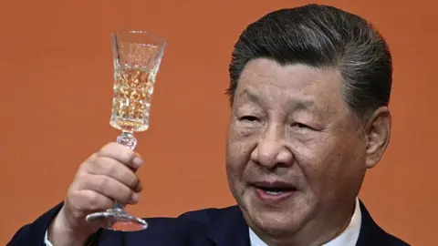 China's President Xi Jinping makes a toast during a state banquet for US President Donald Trump at the Great Hall of the People in Beijing on May 14, 2026.