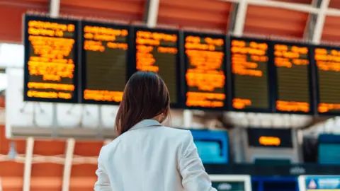 Getty Images A woman at a train station 