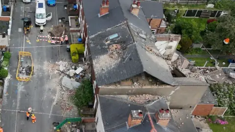 An aerial view of damage to a terrace row of houses