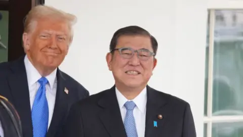 US President Donald Trump, right, and Shigeru Ishiba, Japan's prime minister, shake hands during a meeting in the Oval Office of the White House.