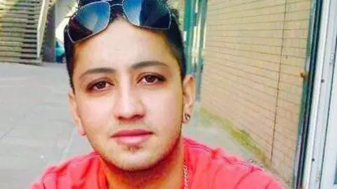 Ahsan Razzaq is pictured when he was younger. He has short dark hair, sunglasses resting on top of his head, and is wearing a pink shirt