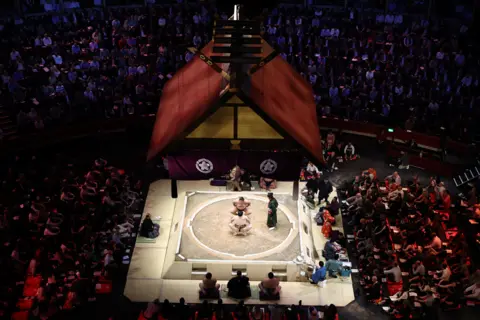 AFP via Getty Images Top shot of Hakuoho facing Oho during their bout on day 2 of the Grand Sumo Tournament at the Royal Albert Hall in central London