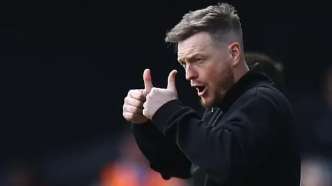 Kim Hellberg gives a double thumbs up on the Boro sideline