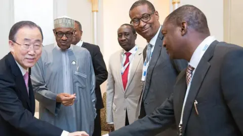 Nurphoto via Getty images Abubakar Malami shakes hands with UN Secretary General Ban Ki Moon as former Nigeria President Muhammadu Buhari and three other people watch
