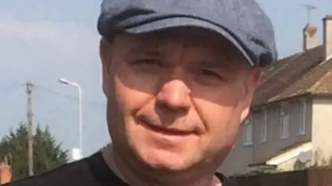 Reading Borough Council A picture of Micky Leng standing in a residential area wearing a blue cap.