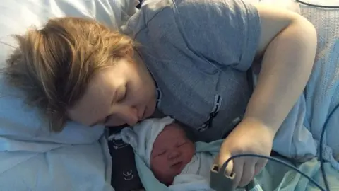 Rebecca Matthews Rebecca Matthews in a hospital bed with her new born child.