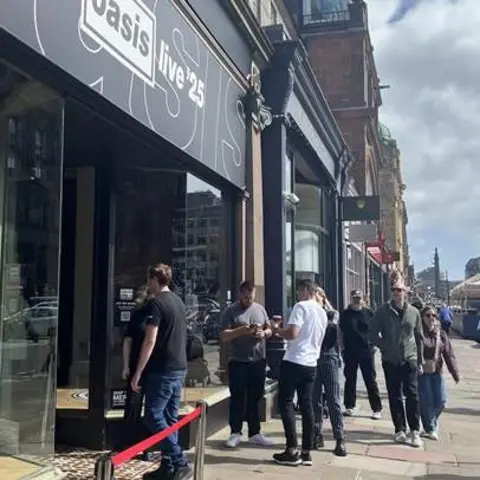 A general view of fans queuing outside the official Oasis fan shop on George Street in Edinburgh.
