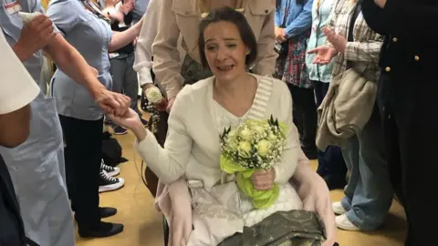 LOROS Bec Mills with a bouquet at her LOROS wedding ceremony