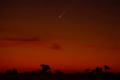 Borja Suarez/REUTERS A view shows Comet C/2023 A3 (Tsuchinshan-ATLAS), known as the comet of the century, photographed before sunrise from Arinaga, on the island of Gran Canaria, Spain, September 27, 2024. 