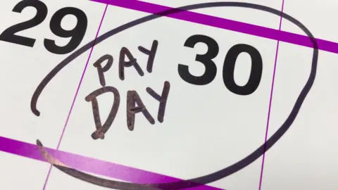 Getty Images A calendar showing 'pay day' highlighted on the 30th of an unknown month - it is a stock photo