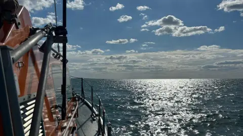 Wells RNLI A large all weather lifeboat sailing towards the horizon
