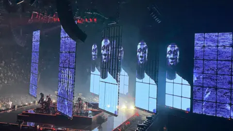 Picture of large screens on stage showing Stormzy