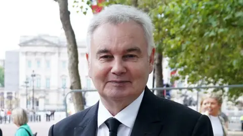 PA Media A file photo from 2022 shows Eamonn Holmes, wearing a black suit, near The Mall in London