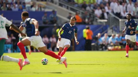 Getty Images Action photo showing France's Michael Olise attempting a pass to team-mate Kylian Mbappe during the France v Senegal World Cup match on 16 June 2026