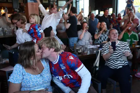 Reuters Fans kiss inside a pub after watching Crystal Palace win the FA Cup