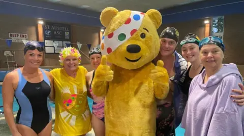 Cornwall's team of Julie Skentelbery, Hannah Stacey, David Dixon, Lou Symons, Daphne Skinnard and Francesca Carpenter in front of a swimming pool.