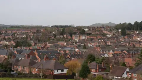 PA Media An overhead view of Ashbourne, showing a lot of brick buildings with an overcast sky.