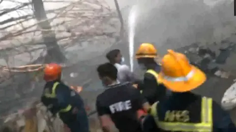 Firefighters douse flames after plane crash