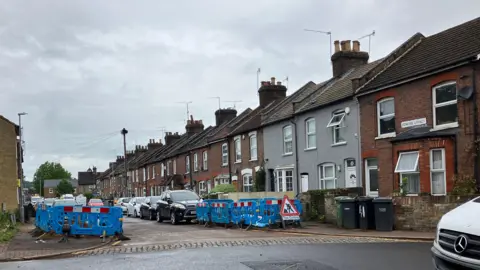 Louise Parry/BBC Edward Street seen from the same angle as the above photo but without the trees. Where they stood are blue barriers and a roadworks sign saying "Tree Cutting"