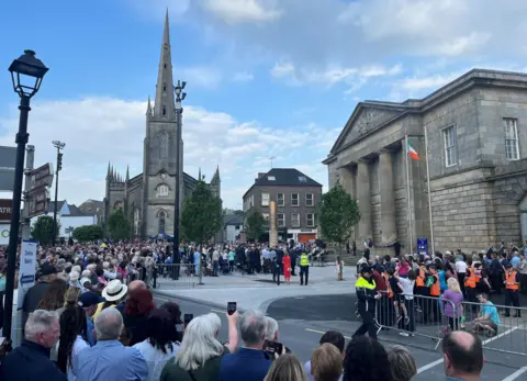 A crowd of people at a memorial event in Monaghan