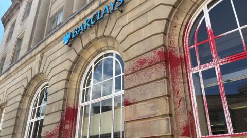 Barclays Bank with red paint over it