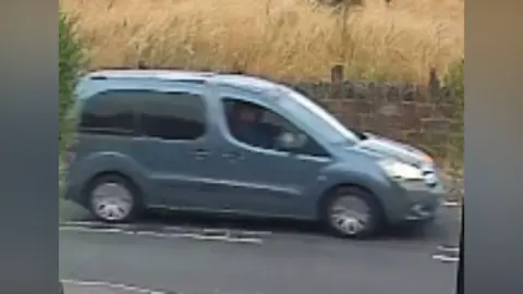 CCTV footage of a blue Citroen Berlingo driving on a rural road.