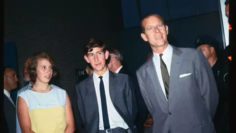 Getty Images Prince Charles, seen here with his father and sister, took a moment to speak to reporters at New York's Kennedy airport during a stopover on their way back to London after attending the Commonwealth Games in Jamaica