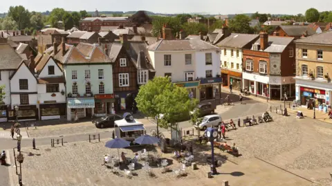 Hitchin BID Aerial shot of Hitchin town centre showing historic shop fronts and a town square