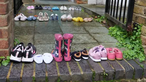 PA Media Children's shoes left on the doorstep of Keir Starmer's house