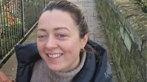 Dr Danielle Verity An outside selfie of Dr Danielle Verity as she stands on a path with a fence running along beside her