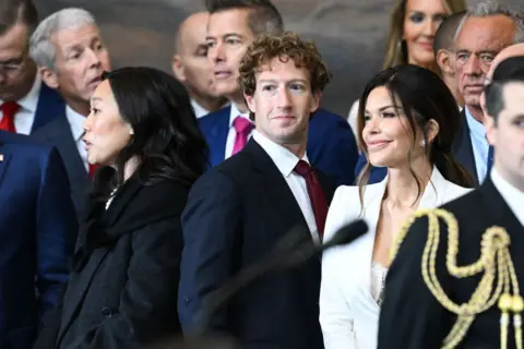 Getty Images Mark Zuckerberg stands next to Lauren Sanchez in the middle of a crowd at Trump's inauguration