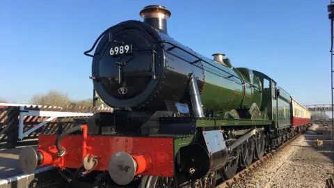 A green and black locomotive  
