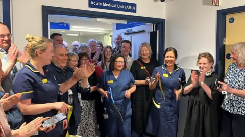 Staff at the Royal Sussex County Hospital in Brighton cutting the ribbon on the new Acute Medical Unit. Sister Gladys Gonsalves can be seen cutting the yellow ribbon for the new facility.
