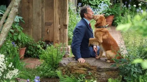 Reuters Gardening expert Monty Don plays with his dog, Ned, at the RHS and BBC Radio 2 Dog Garden at the Chelsea Flower Show