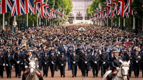 PA Media Packed crowds on the Mall as members of the public line up to watch flypast. The Mall is lined by UK flags