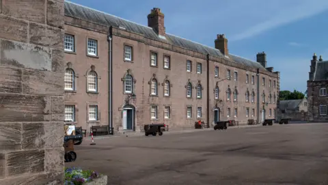 Maltings Trust The eighteenth century Berwick barrack, a large continuous building around a parade ground with lots of windows and field guns in front of every door