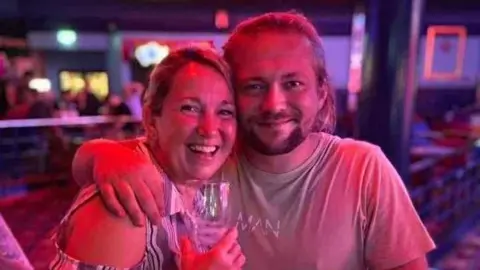 Ashley Southall Ashley Southall with his mother Michelle. They are out in a darkly-lit room with pink and purple lights. He has his arm round her. They are both smiling and she is holding a glass.