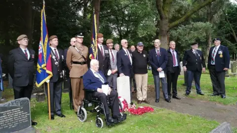 Washington History Society Service attendees standing next to Guardsman Graeme Lawson's grave in Washington at the service on Sunday