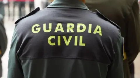 A Spanish police uniform that says, Guarda Civil on the back.
