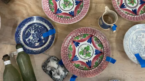 Various items of multi-coloured pottery recovered from a shipwreck