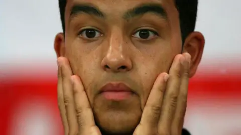 Theo Walcott holds face